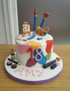 a birthday cake decorated with art and craft supplies