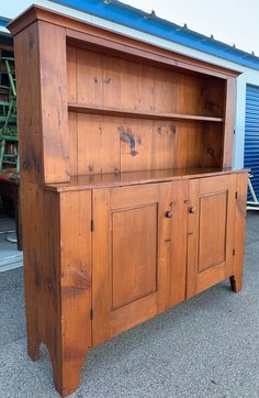 an old wooden cabinet with doors and drawers