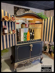 an old fashioned bar with liquor bottles on the top and shelves above it in a store