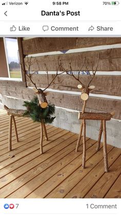 two wooden reindeer statues sitting next to each other on a wood flooring covered porch