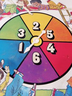 a close up of a clock with children on it's face and numbers in the middle