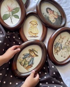 four framed pictures of children's animals are shown in the shape of frames on a bed