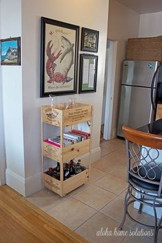 there is a wine rack in the corner of this kitchen with pictures on the wall