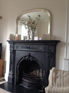 a living room with a fireplace and mirror