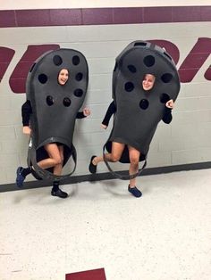 two people in black bodysuits with holes on them