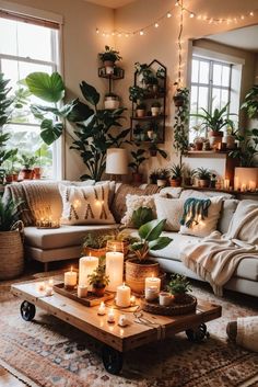 a living room filled with lots of plants and candles on top of a coffee table