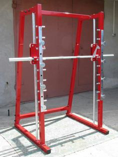 a red and silver gym frame on the ground