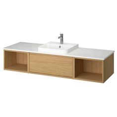 a white sink sitting on top of a wooden cabinet