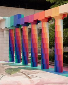 colorful columns are lined up in front of a building