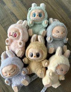 a group of stuffed animals sitting on top of a wooden floor