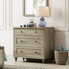 a bedroom with a dresser and mirror in it