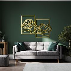 a living room scene with focus on the couch and wall art that has green paint