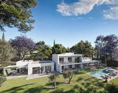 an aerial view of a house and pool in the middle of a park with trees