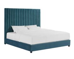 a bed with a blue headboard and white sheets