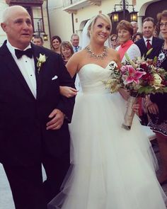 a bride and groom walking down the aisle