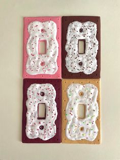 three decorative light switch plates in the shape of doughnuts