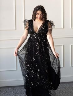 The Starry Eyed Sequin Star Mesh Maxi Dress is a Confête favorite. Starry Eyed features an a-lined silhouette, deep v-neck, glitter stars and a slight ruffle cap sleeve. Fully lined. Hidden back zipper enclosure. 100% poly. Hand wash cold. Comes in black and gold. Pictured in S and L. Celestial Formal Dress, Moon Themed Wedding Dress, Celestial Ball Gown, Elven Dresses, Vestidos Curvy, Moon Wedding Theme, Bridesmaids Styles, Glitter Maxi Dress, Creative Black Tie