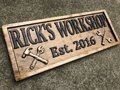 a wooden sign that says rick's workshop est 2016