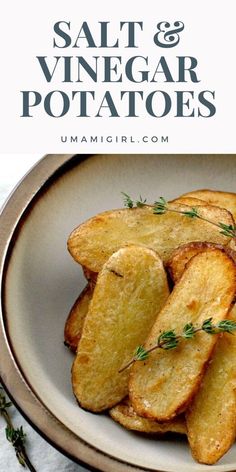 a white plate topped with sliced potatoes on top of a table