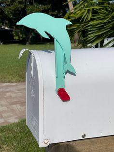 a close up of a mailbox with a dolphin painted on it