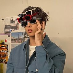 a woman with sunglasses on her head talking on a cell phone in front of a desk