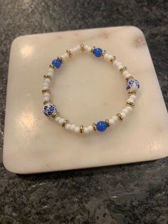 blue, white, and gold beaded bracelet. Blue And Gold Bracelets, Gold Beaded Bracelet, Bracelet Inspo, Blue Beaded Bracelets, Rosary Bracelet, Gold Bead Bracelets, White Gold Bracelet, Bracelet Ideas, Cute Bracelets