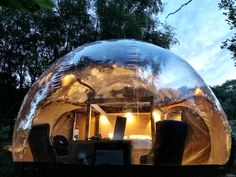 an inflatable tent is lit up at night with lights on the outside and inside