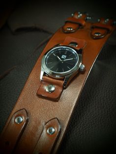 "This leather cuff watch uses Rich tan hand dyed full grain vegetable tanned leather. Hand aged hardware and brand new water resistant FM watchface w/ 316L stainless case, sapphire crystal,and Japanese quartz movement complete the look!  I'll need your wrist size for this watch. Please use the instructions in the pics above! - 2.25\" wide - Vegetable tanned leather - FM water resistant black face Thanks Freddie ✻ Please leave all size information in the notes to seller at the end of checkout! Yo Vintage Leather Watch, Handmade Vintage Watches, Handmade Brown Watch For Everyday Use, Vintage Leather Watch Accessories For Everyday Use, Handmade Vintage Leather Watch, Handmade Brown Watches For Everyday Use, Everyday Handmade Brown Watch, Brown Handmade Watch For Everyday Use, Handmade Vintage Watches For Everyday