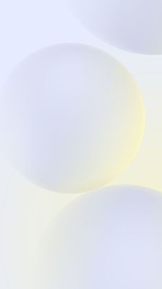 an abstract image of white circles on a light blue and yellow background that is slightly blurry