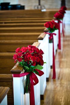 red roses tied to pews in a church