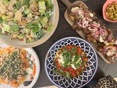 several plates of food on a wooden table