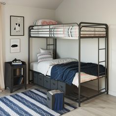 a bunk bed with drawers underneath it and a rug on the floor next to it