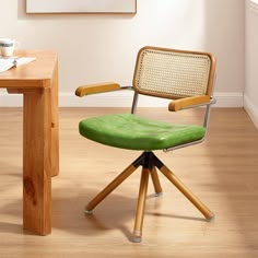 a green chair sitting in front of a wooden table