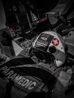 a helmet sitting on top of a black and white motorcycle with the words paramedic written on it