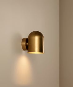 a wall light that is on the side of a wall with a white wall behind it