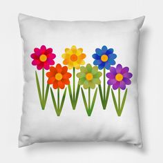 a white pillow with colorful flowers on the front and back sides, all in different colors