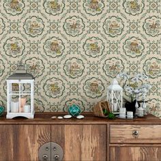 a wooden dresser topped with lots of drawers next to a wallpaper covered in green and white designs