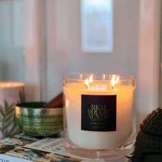 a candle sitting on top of a table next to other candles