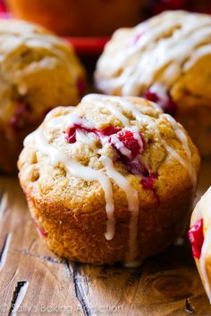 cranberry muffins with icing on a wooden table