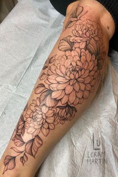 a person with a flower tattoo on their leg