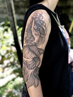 a woman with a tattoo on her arm