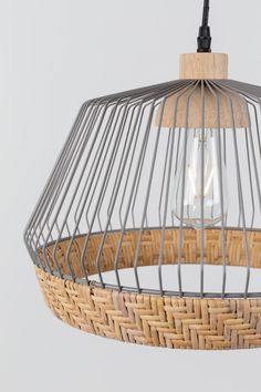 a light that is hanging from a wire and wicker lamp fixture with a wooden handle