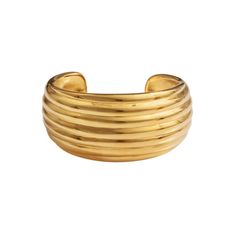 Elevate your accessory collection with the Pajarito cuff, a stunning example of minimalist design. Handcrafted with 24K gold-plated metal alloy and featuring clean, ridged lines, this bangle embodies simplicity and elegance. All jewelry is handcrafted and made to order in our New York City design studio. Please allow 7-14 business days for production from the order date. Measurements: 2 3/4" x 1 1/4" diameter Luxury Brass Cuff Jewelry, Modern Gold-tone Gold Plated Cuff Bracelet, Luxury Tarnish-resistant Gold-plated Cuff Bracelet, Luxury Gold-plated Cuff Bracelet With Polished Finish, Modernist Polished Cuff Jewelry, Beachy Necklace, Gold Cuffs, Classic Gold, Hair Ornaments