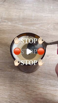 a person holding a spoon with the words stop on it