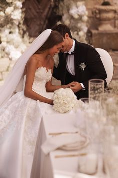 a bride and groom sitting at a table