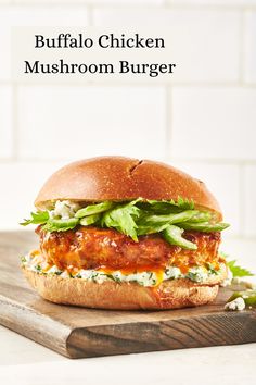 the buffalo chicken mushroom burger is on a cutting board with lettuce and cheese