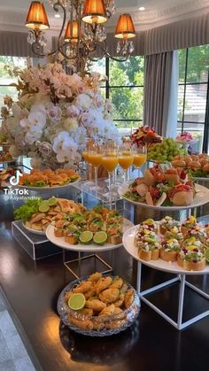 a buffet table filled with lots of different types of food and drinks on it's trays