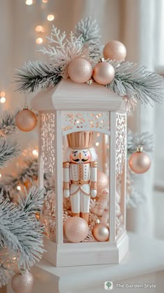 a white lantern surrounded by christmas decorations