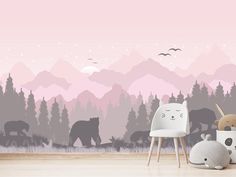 two stuffed animals are sitting in front of a wall mural with mountains and bear silhouettes