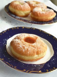 two blue and white plates with donuts on them